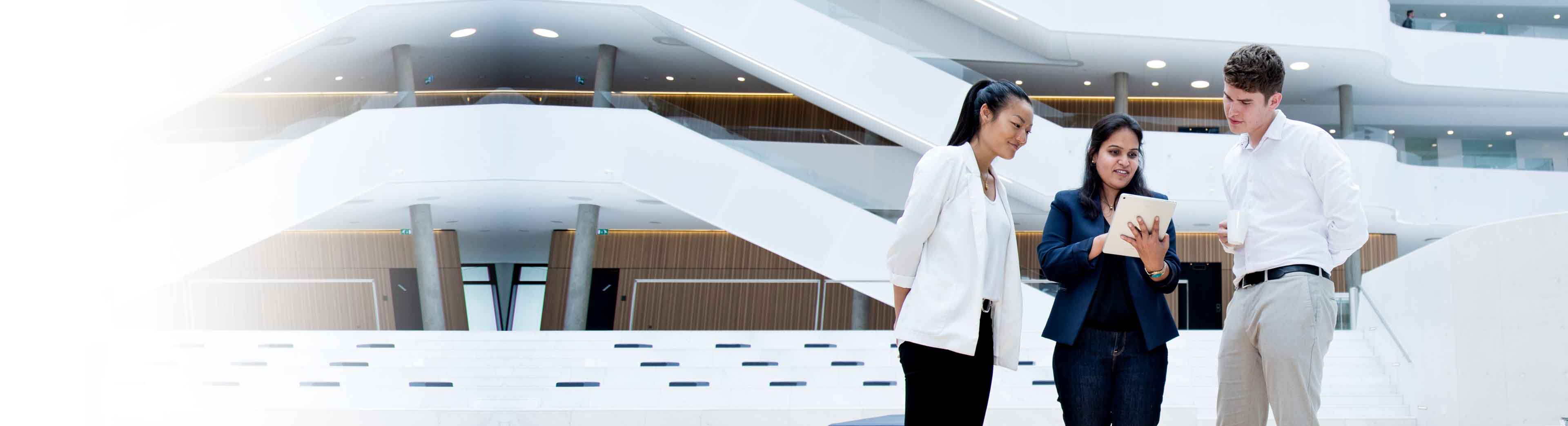 Three young trainees in a discussion at the DSV headquarter in Hedehusene